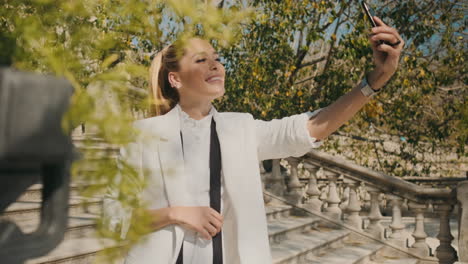 stylish young woman taking selfie outdoors.