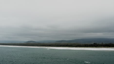 Aerial-drone-shot-of-Seven-Mile-Beach-on-a-stormy-day-in-the-south-coast-of-NSW,-Australia