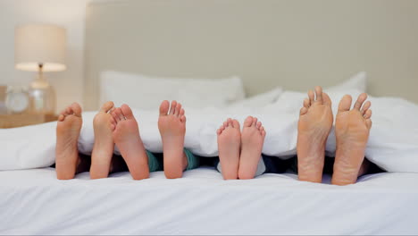 sleeping, feet and family wake up in a bed