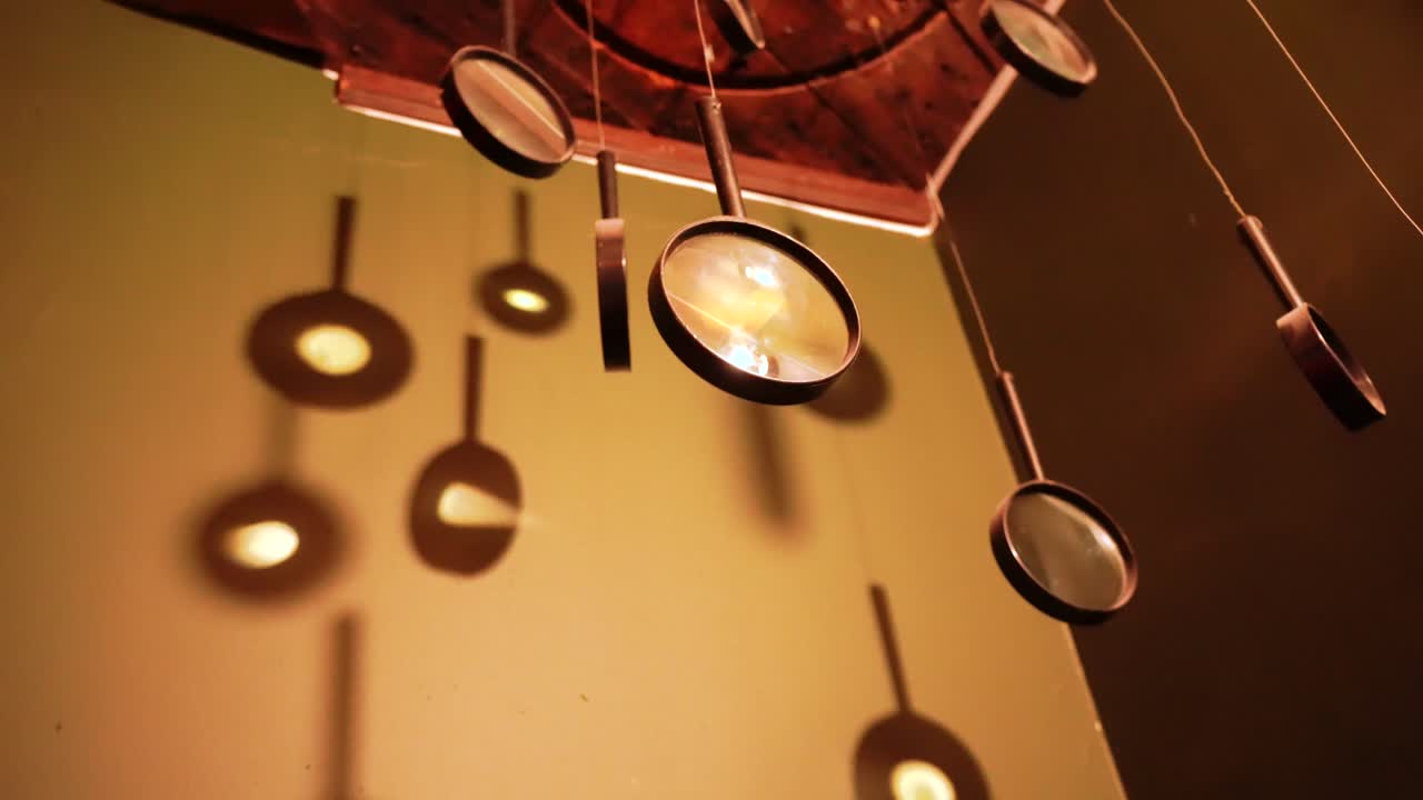 Hanging magnifying glass in the corner of a room.