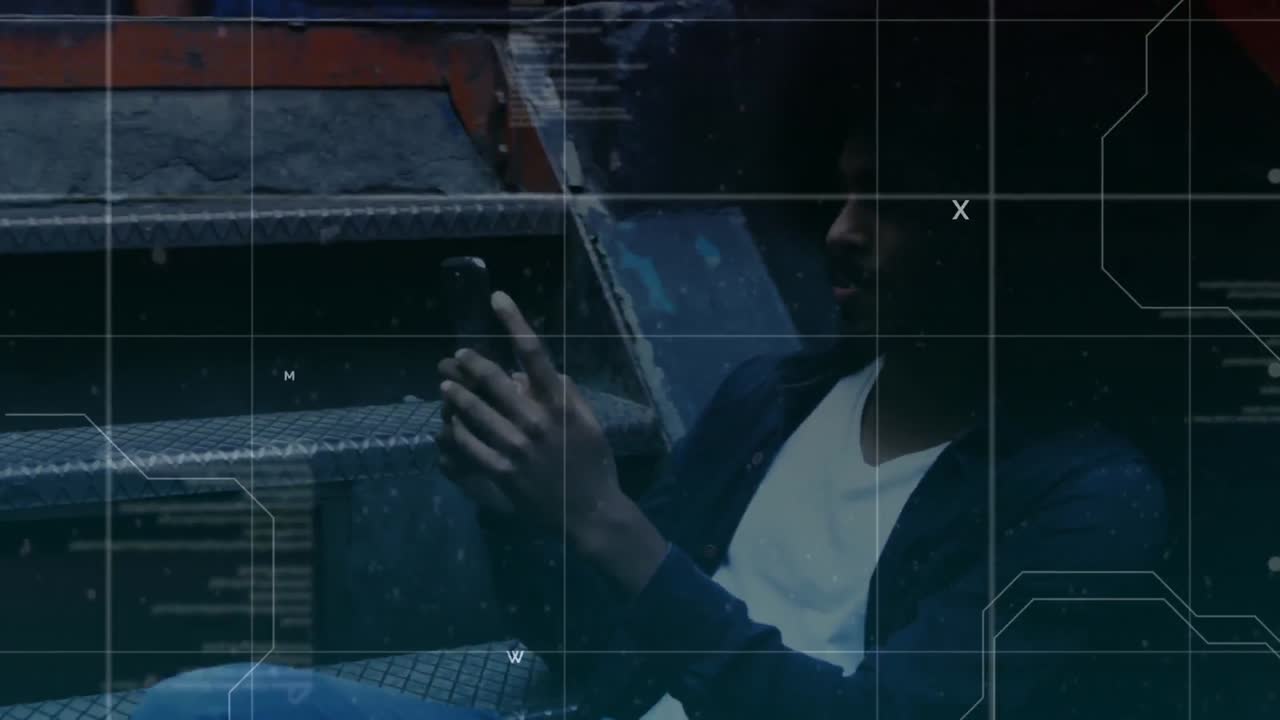 Male sitting on stairs using mobile phone