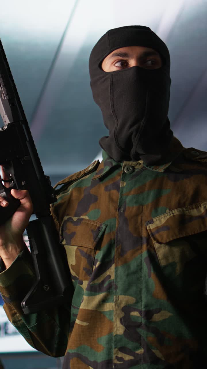 Vertical video Insurgent inspecting room during enemy base assault