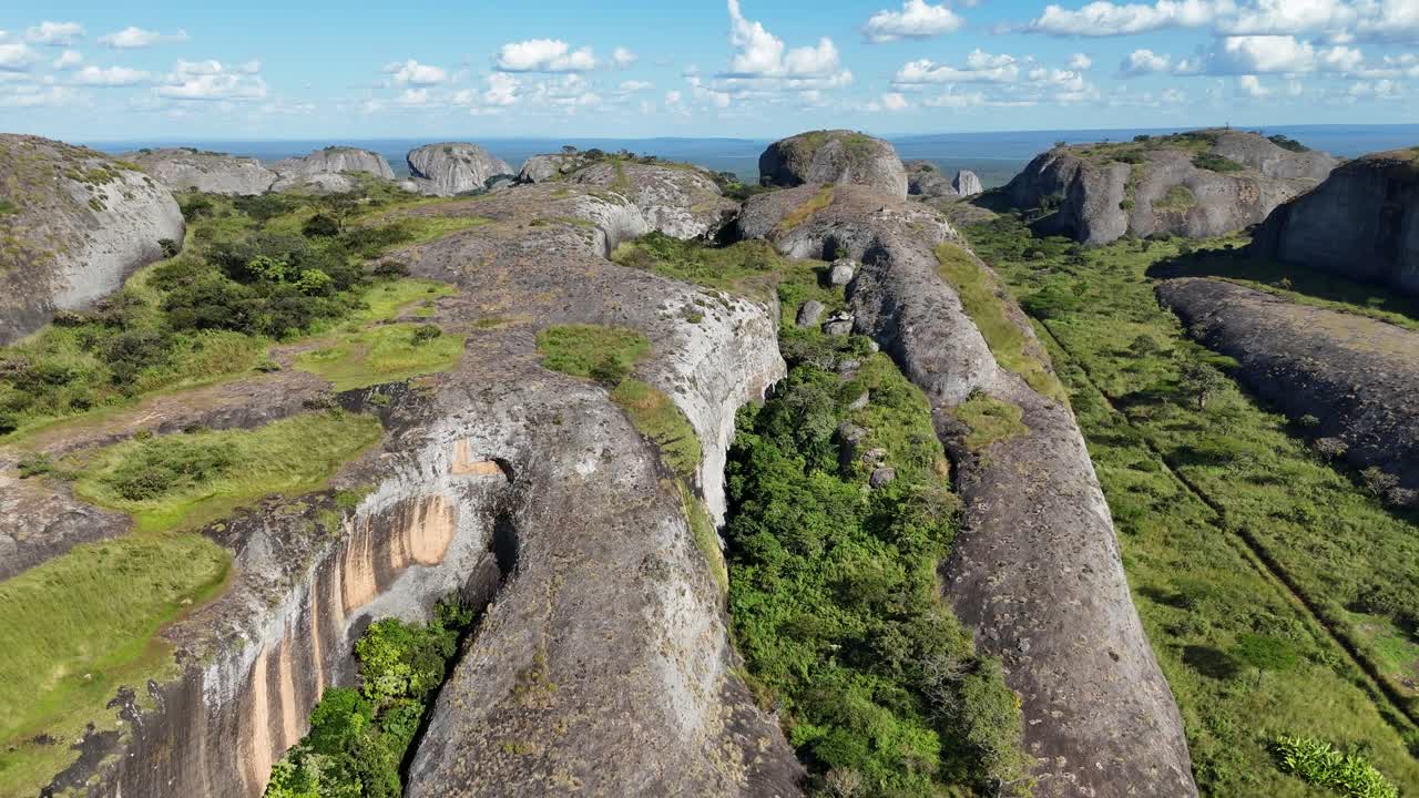 High aerial footage of Pedras Negras, Angola, displaying unique volcanic rock formations and scenic textures shaped by erosion over centuries