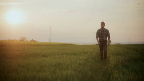 Farmer-Walking-Amidst-Grass-In-Farm