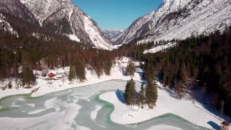 Lago-del-Predil,-Tarvisio---Italy-a-frozen-alpine-lake-in-a-snow-covered-winter-fairytale-mountain-landscape