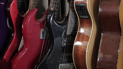 rack of guitars in a performing arts classroom, tilt up