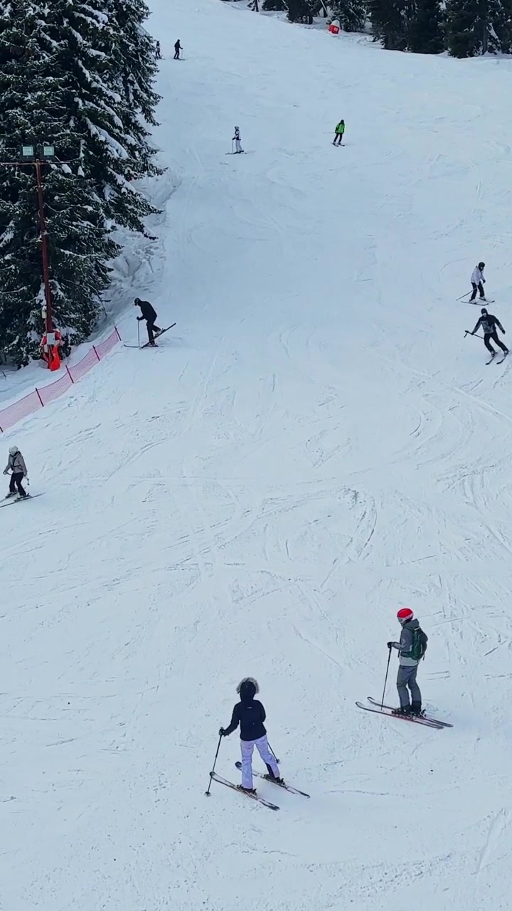 Skiers enjoy a winter day on the slopes in the Carpathians in Bulgaria