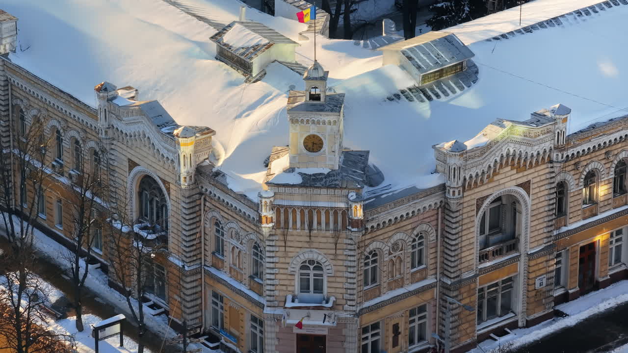 Aerial drone view of Chisinau City Hall covered in snow at sunset. Moldova