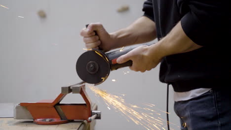 young man working metal with tools