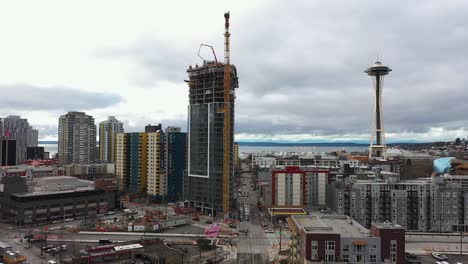 aerial of a skyscraper being constructed near the seattle space needle