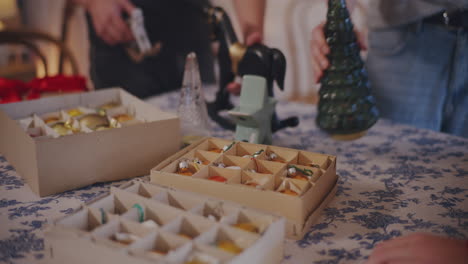 man and women placing christmas ornaments