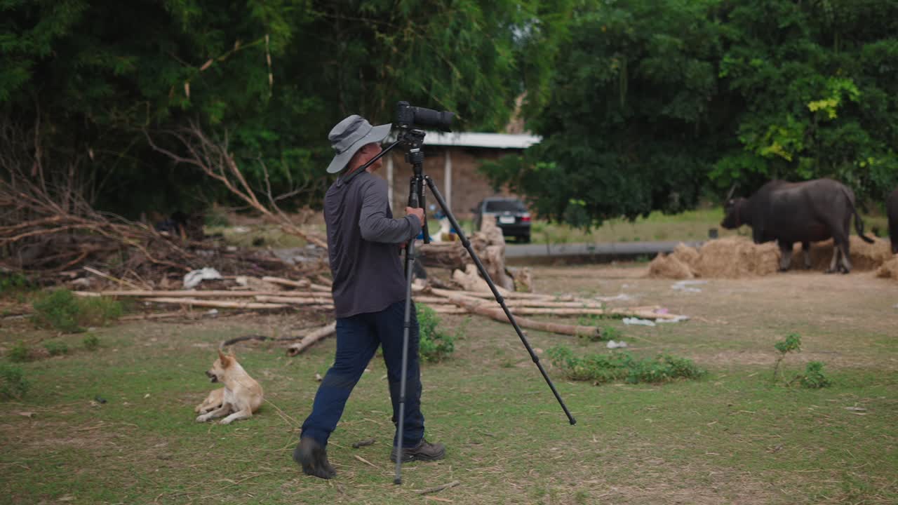 Photographer shooting video in a rural field
