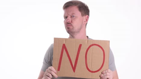 a man holding a 'no' sign with a displeased expression