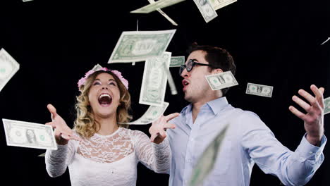 happy couple celebrating with money rain