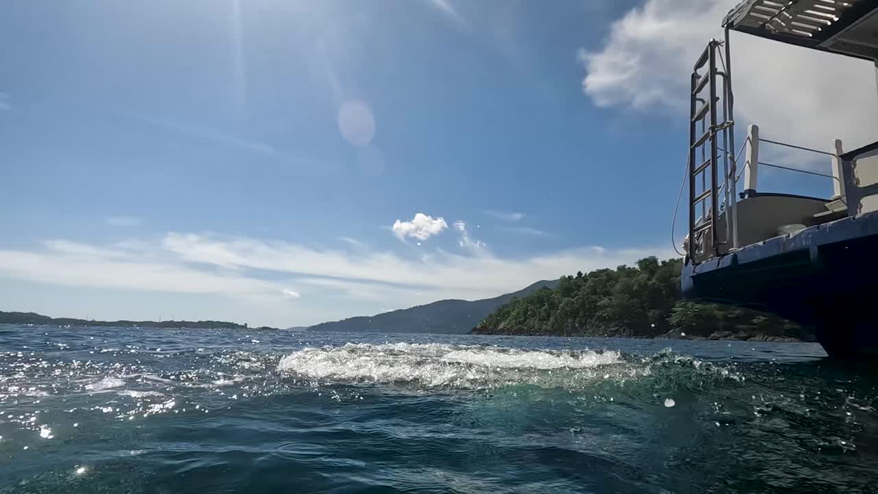 스쿠버 다이빙 장비를 입은 여성이 보트에서 바다로 발을 내딛습니다.