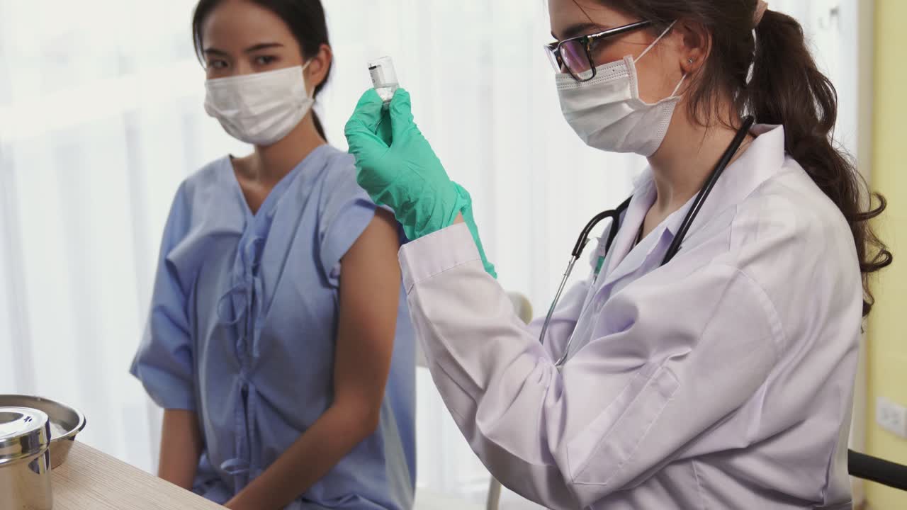 Young woman visits skillful doctor at hospital for vaccination