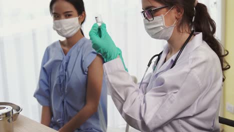 young woman visits skillful doctor at hospital for vaccination