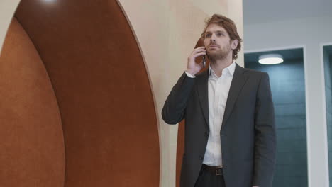 red-haired businessman having telephone conversation