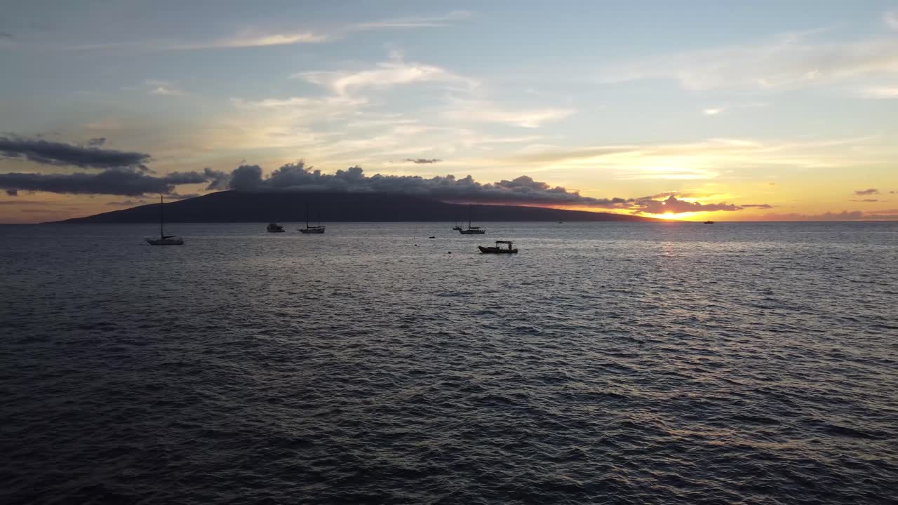 Sunset over the Ocean with Sailboats and Island