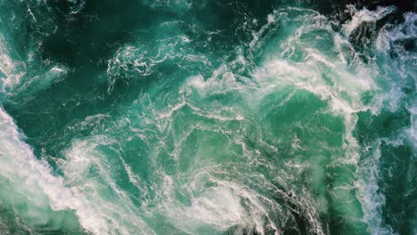 blue waves of water of the river and the sea meet each other during high tide and low tide.