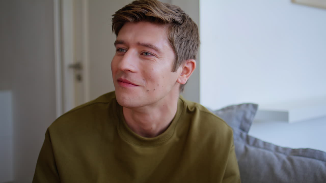 Young man chewing food talking friend at home closeup. Youngster enjoying tv