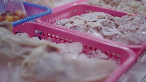 raw chicken wings display at a market