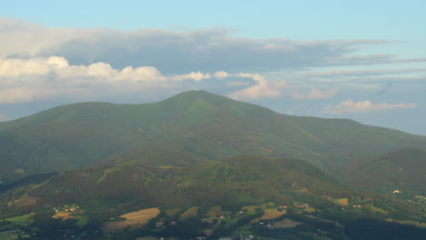 Zoom-inside-the-top-of-Lyse-Mountain-where-lies-a-large-radio-transmitter-view-during-a-sunny-day-in-the-background-with-moving-thick-clouds