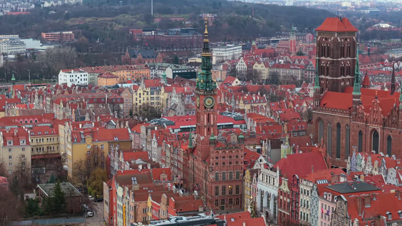 Main Town Hall in Gdansk with St Mary church on the right surrounding gothic architecture buildings on famous Dluga and Mariacka street in the evening, Aerial view