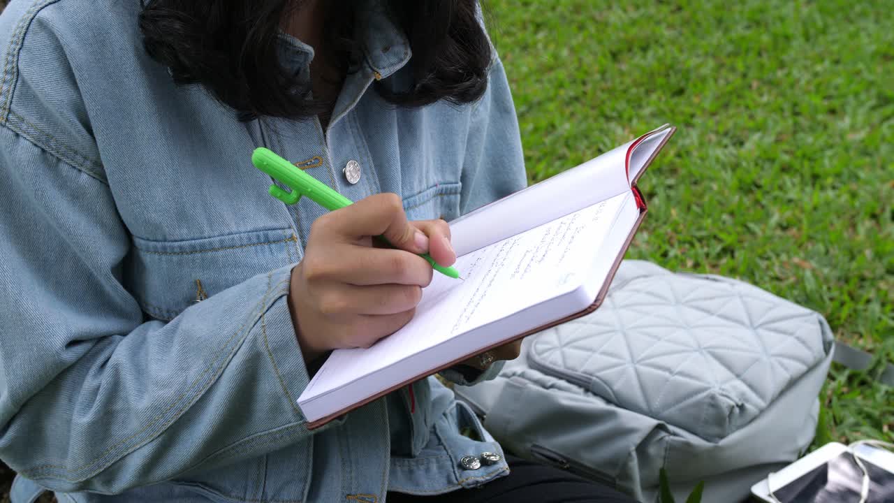 Girl Student Writing Something On Notebook, Video In 4K