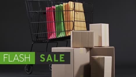 Animation-of-flash-sale-text-over-shopping-trolley-and-gift-boxes