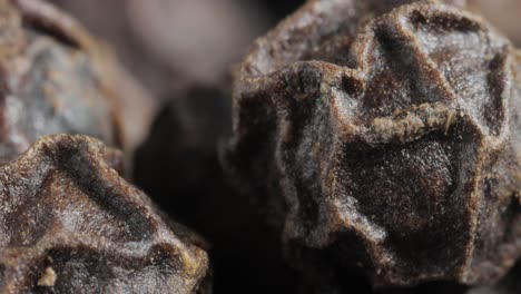 peppercorns or black pepper spice. super macro close up.