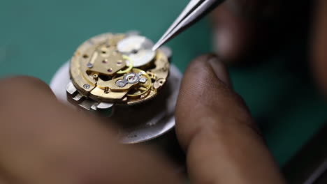 close-up-footage-of-a-craftsman-delicately-repairing-a-vintage-watch