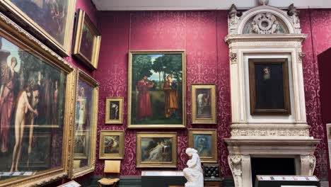art museum gallery paintings on red wall