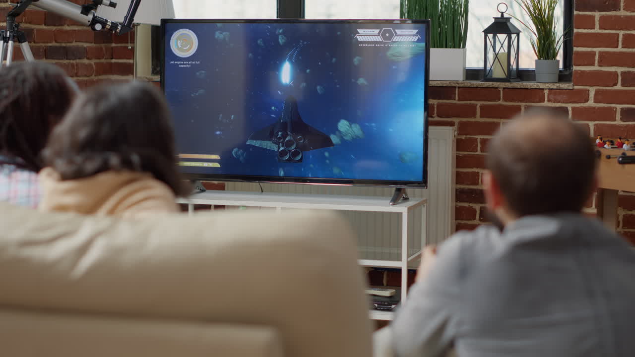 Cheerful people playing shooting video games on television