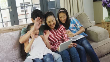 family having a video call on laptop in living room 4k