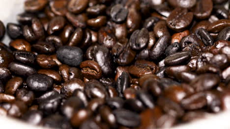 roasted coffee beans falling into the grinder