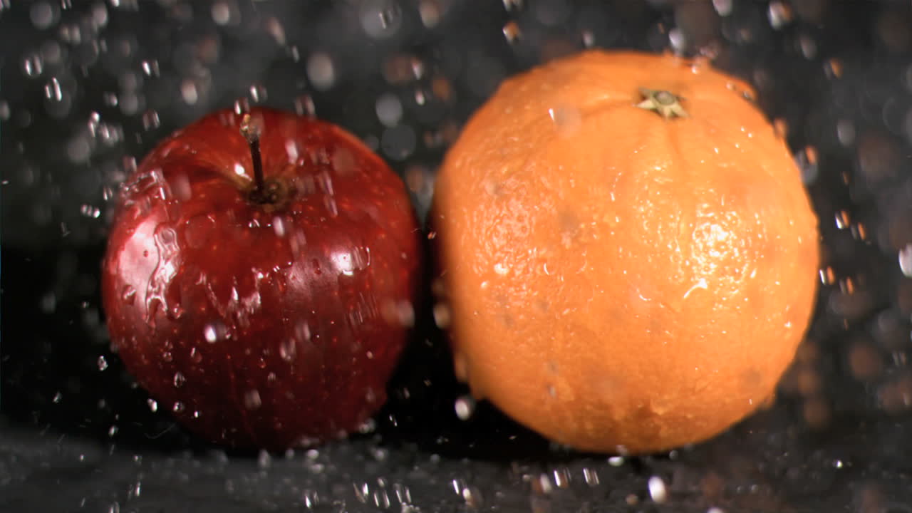 Water raining on fruits in super slow motion