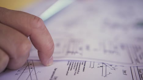 Person reviewing architectural building plans