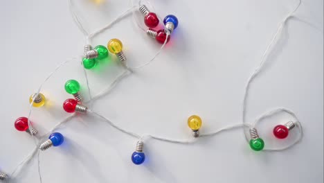 a top-down view showcases christmas led lights in blue, red, yellow, and green displayed on a white surface