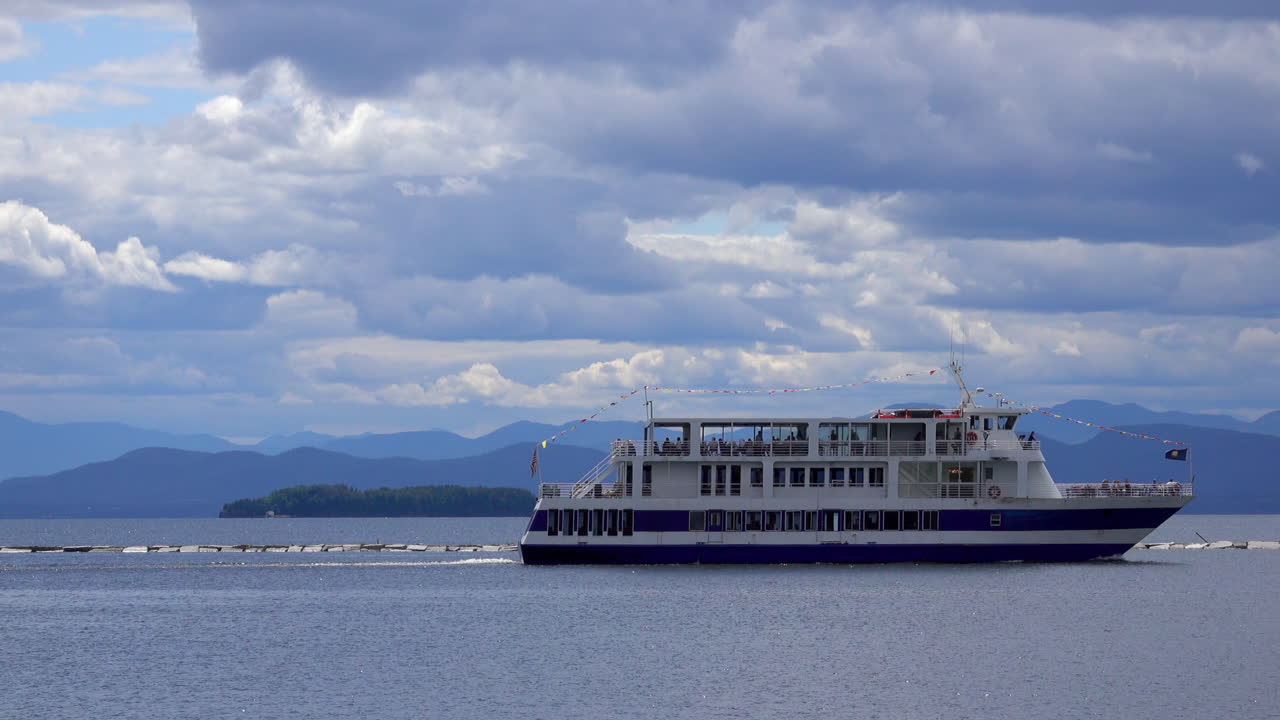 A riverboat cruises past a jetty on Lake Champlain