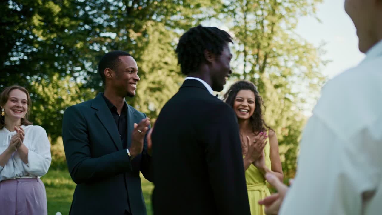 Group of people applauding outdoors
