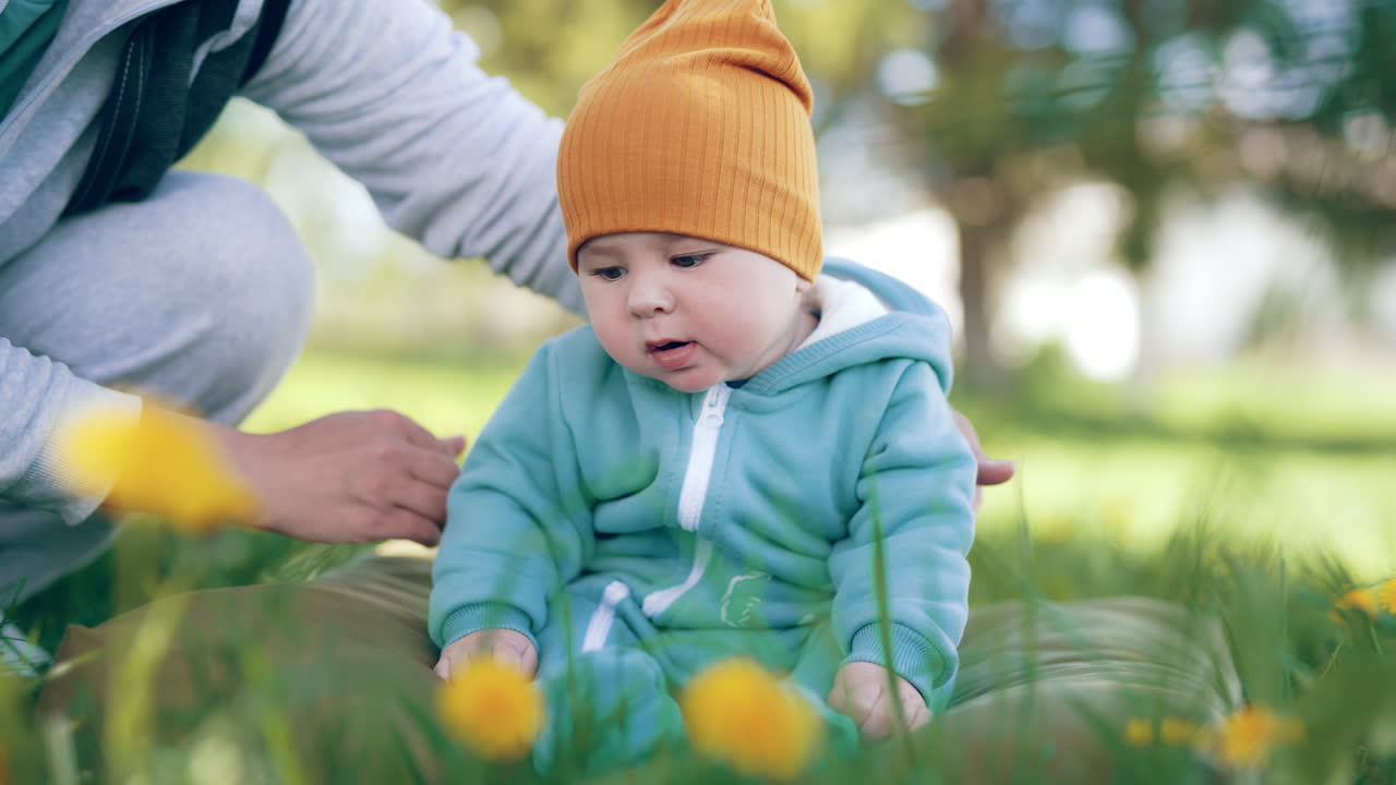 Sleepy baby boy yawns and falls aside. Mother catches her little son and picks him up and puts on belly.