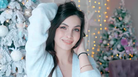 woman smiling in front of christmas trees