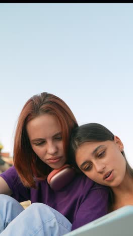 two young women looking at a tablet