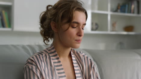 Thinking-woman-considering-answer-resting-on-couch-in-living-room-closeup.