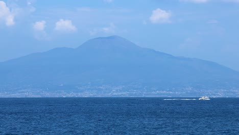 boats moving across the sea near mount vesuvius