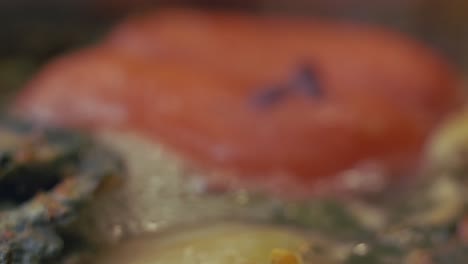 tomatoes and onions cooking in a delicious vegetable soup - extreme close up