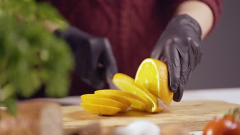 close-up of hands slicing a ripe, juicy orange on a wooden cutting board. the bright citrus fruit is freshly cut, showcasing its natural texture, freshness, and vibrant color in a detailed macro shot