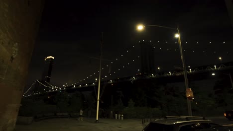 gimbal reveal of the brooklyn bridge against dark night - street view new york