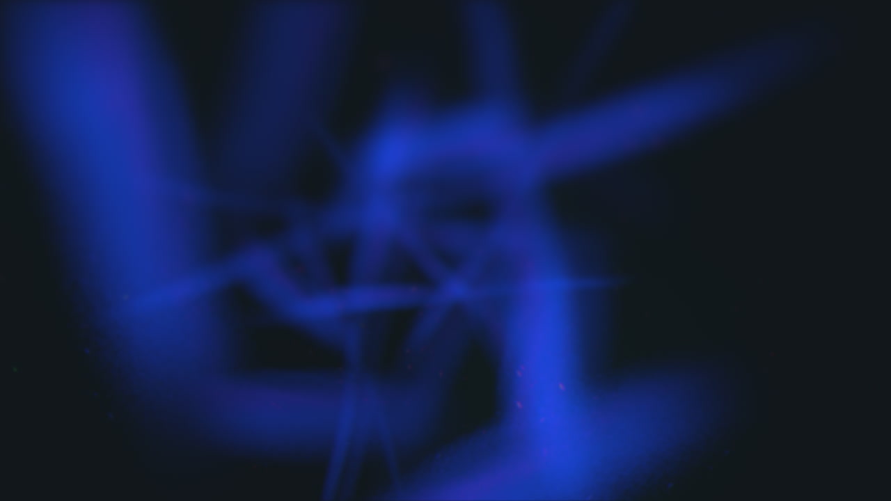 Un'immagine di una luce radiosa a forma di stella blu che emana dal centro con bordi frastagliati, su uno sfondo nero, creando un effetto visivo ipnotizzante e accattivante.